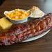 Smokehouse 52's full rack of baby back ribs, with a side of smokehouse baked mac, loaded potato salad and a a piece of Jiffy cornbread.